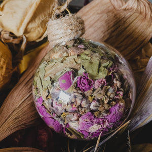 Round glass ornaments, handmade and filled with dried flowers and grasses.