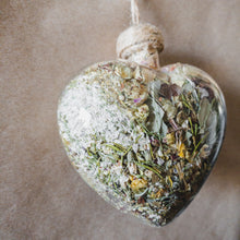 Load image into Gallery viewer, Large glass heart filled with dried areca palm, white rose petals, chrysanthemum buds, baby&#39;s breath and orange lily.
