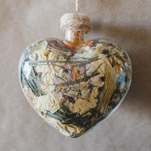 Load image into Gallery viewer, Large glass heart filled with dried areca palm, white rose petals, chrysanthemum buds, baby&#39;s breath and orange lily.
