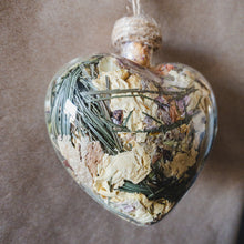 Load image into Gallery viewer, Large glass heart filled with dried areca palm, white rose petals, chrysanthemum buds, baby&#39;s breath and orange lily.
