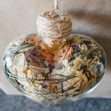 Load image into Gallery viewer, Large glass heart filled with dried areca palm, white rose petals, chrysanthemum buds, baby&#39;s breath and orange lily.
