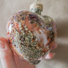 Load image into Gallery viewer, Large (3.5 inches wide by 4 inches tall) glass heart filled with dried orange lilies, pink rose petals, baby&#39;s breath and devil&#39;s ivy flower.
