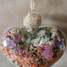 Load image into Gallery viewer, Large (3.5 inches wide by 4 inches tall) glass heart filled with dried orange lilies, pink rose petals, baby&#39;s breath and devil&#39;s ivy flower.
