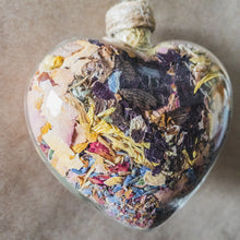 Load image into Gallery viewer, Large (3.5 inches wide by 4 inches tall) glass heart filled with dark purple orchids, lavender, pink rose petals and rosebuds.
