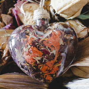 Large (3.5" wide x 4" tall) glass heart filled with red rose petals, pink carnation petals, orange and white lilies.