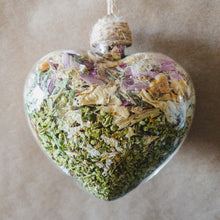 Load image into Gallery viewer, 3.5&quot; wide x 4&quot; tall glass heart filled with dried pink strawflower, white roses and green hydrangea.
