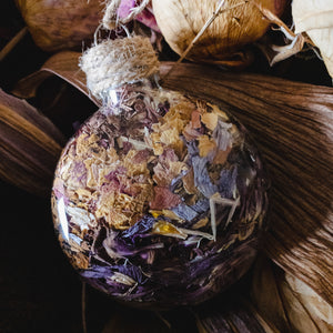 Multi-coloured rose petals, purple lilies and orchids.